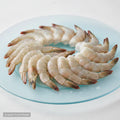 Ecuador farm-raised raw shrimp on a light blue plate, fresh and ready for cooking